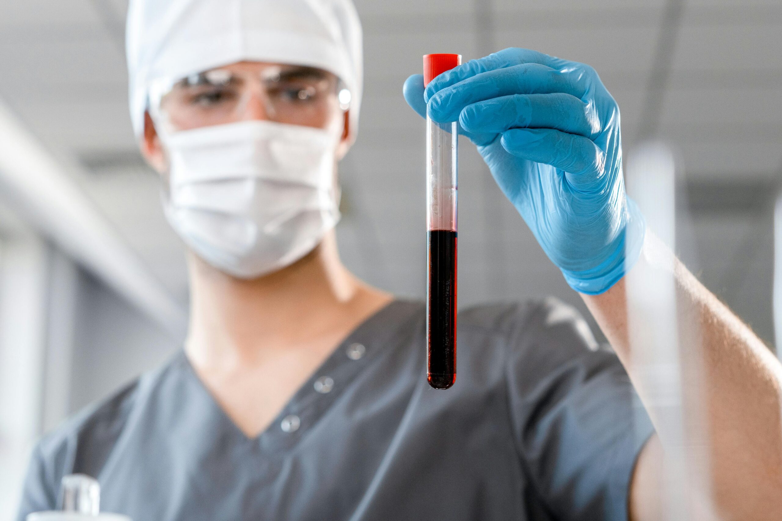 Doctor examining a blood sample in a laboratory setting, showcasing medical research.